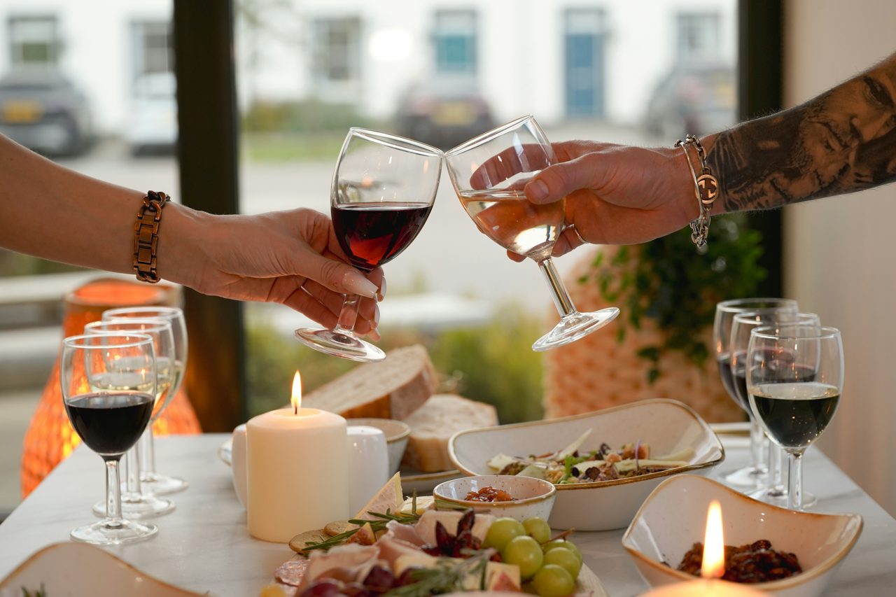 Couple sharing tapas and wine at a candlelit bar in Barcelona
