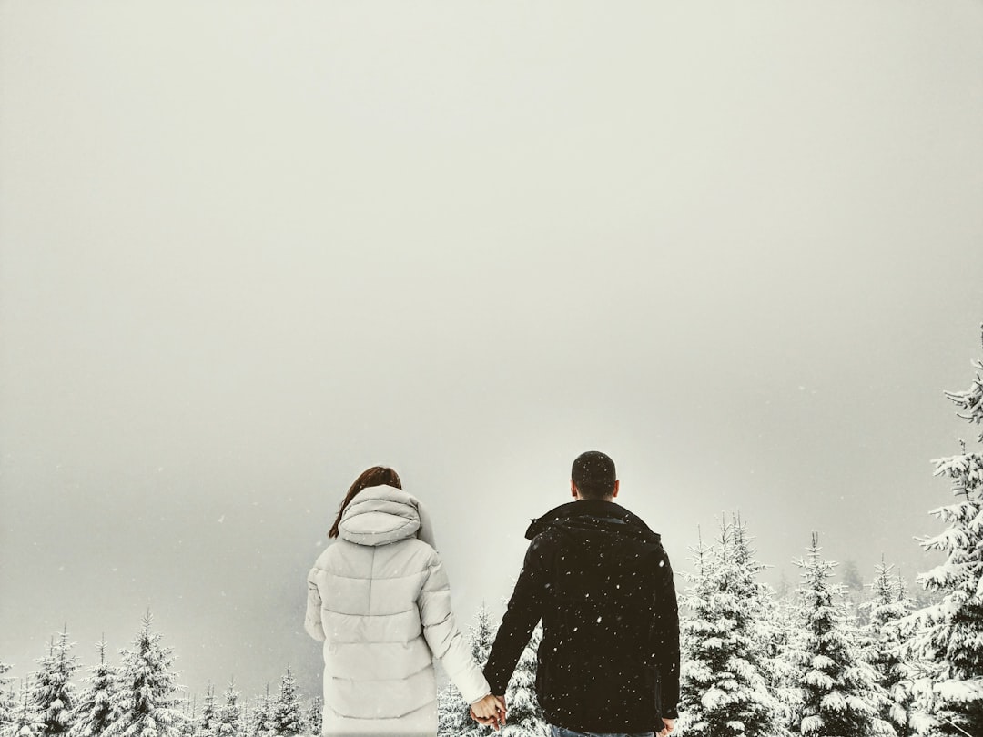A romantic winter proposal in the snow with fairy lights