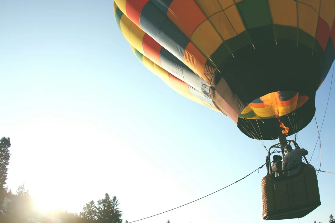 A private balloon basket at sunrise