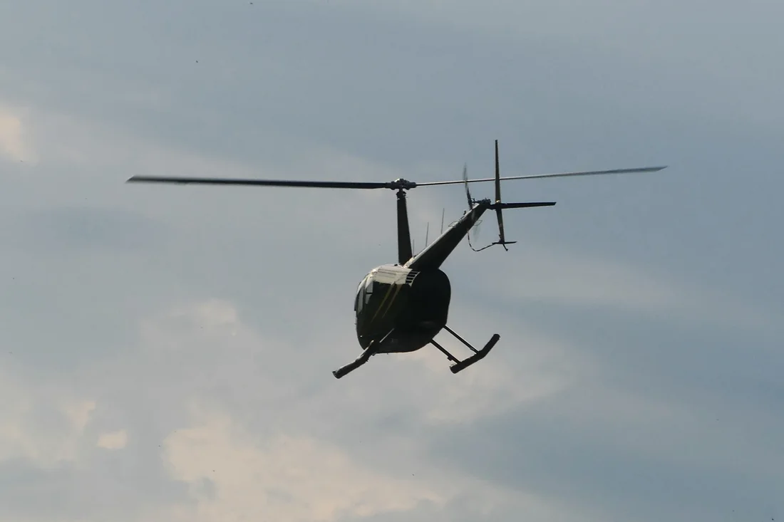 A Robinson R44 helicopter in flight
